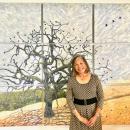Eileen Oda Leaf in front of her tree mural. 
