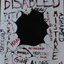 You see a gaping black hole in the center of the canvas as if the wall is being punched and broken. The many labels associated with disabilities are written in black and red of various sizes, some written upside down, sideways and across the canvas. The shattered wall of text crumbles in various spots around the hole.