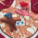 Image of two stuffed sewn monsters on an apron. 