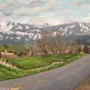 An acrylic painting of a paved two-lane country road leading into the painting toward a snow covered Sierra Nevada Mountain range. To the left the painting is an old wooden fence that runs alongside the road. The left of the painting opens to a field of grass, leafless trees, a distant orchard and rolling foothills. The blue sky is scattered with clouds.