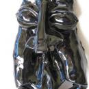 A mask with bulging eyes and a long nose, glazed in black.