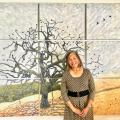 Eileen Oda Leaf in front of her tree mural. 