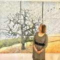 Eileen Oda Leaf in front of her tree mural. 