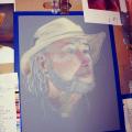 A photo of a drawing of a man with a hat. 